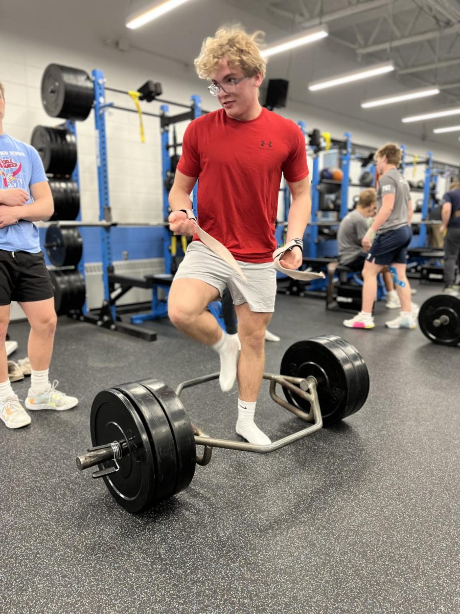 Junior Alexander McDonald prepares for a hex bar deadlift on the lacrosse team's Wednesday April 30 morning lift.  Lacrosse along with many other athletic programs have committed to lifting a minimum of twice a week often happening as early as 6:00 in the morning.