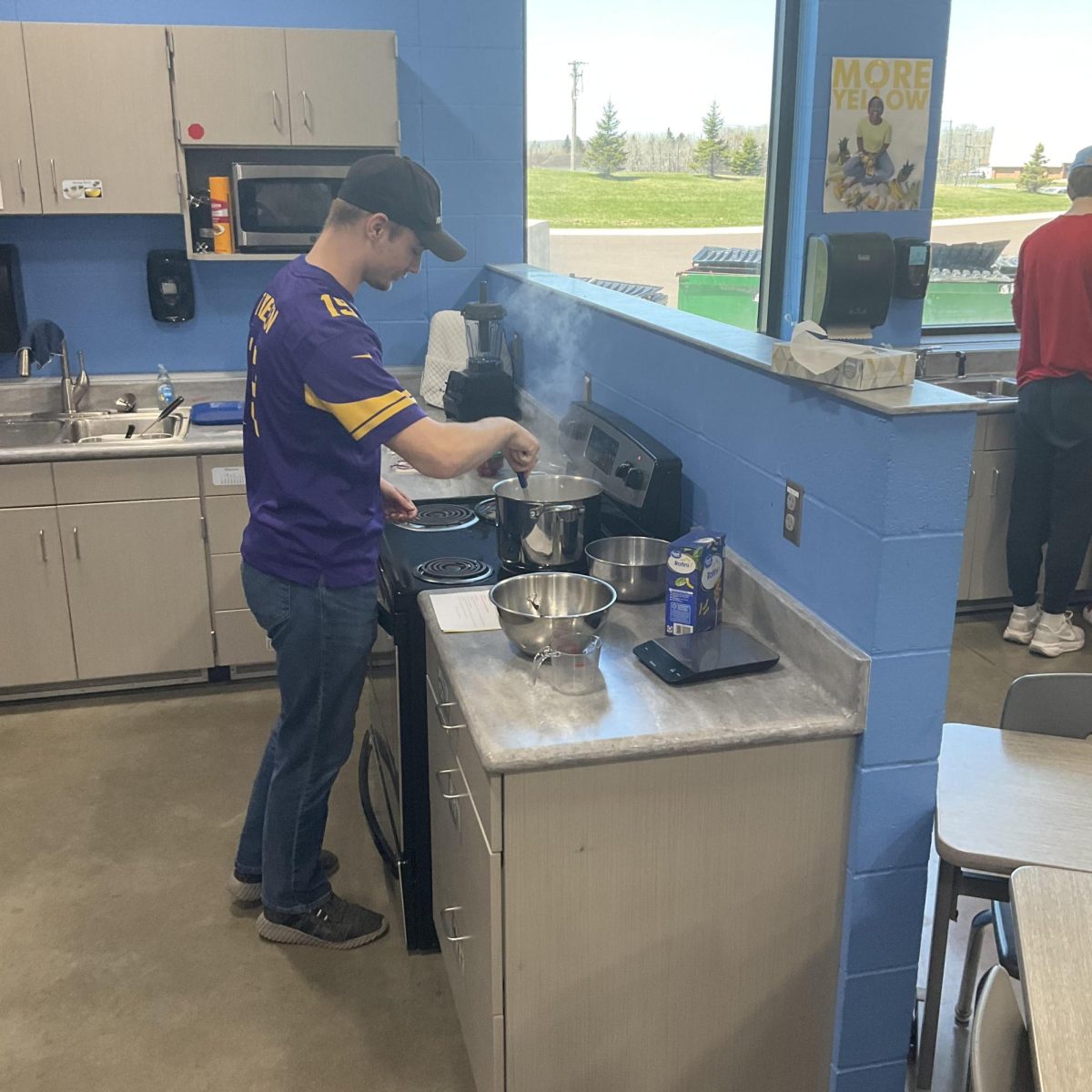 Senior Jackson Nelson cooks wearing a Vikings jersey on May 5, 2025.
