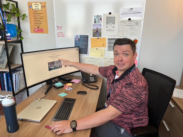 Assistant principal Matthew Amerson points to his favorite conspiracy theory regarding the sinking of the Titanic on May 6, 2025. Amerson hosts a monthly “Conspiracy Hour” with seniors Aurora Doll and Maggie Lehto.