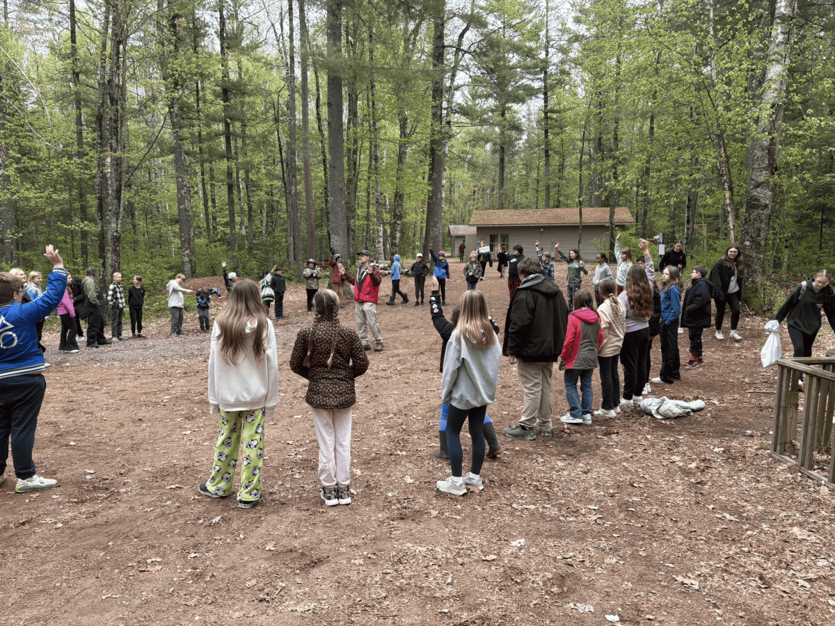 Cooper fifth graders attend a CSI field trip to the Superior school forest on May 21, 2025. The fifth graders gather in a circle as they get ready for activities. 