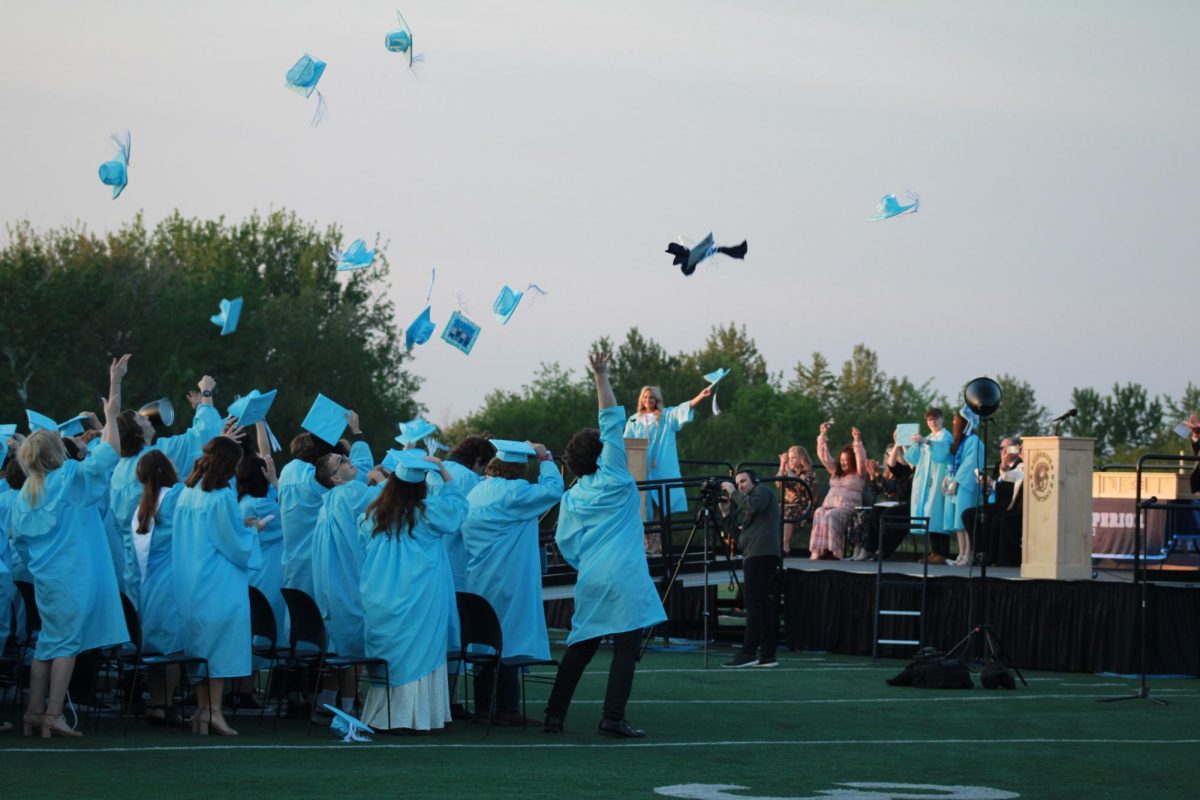 Seniors throw their mortarboards in the air at the 60th commencement ceremony on June 6, 2025. The commencement took place on the football field inside the NBC Spartan Sports Complex