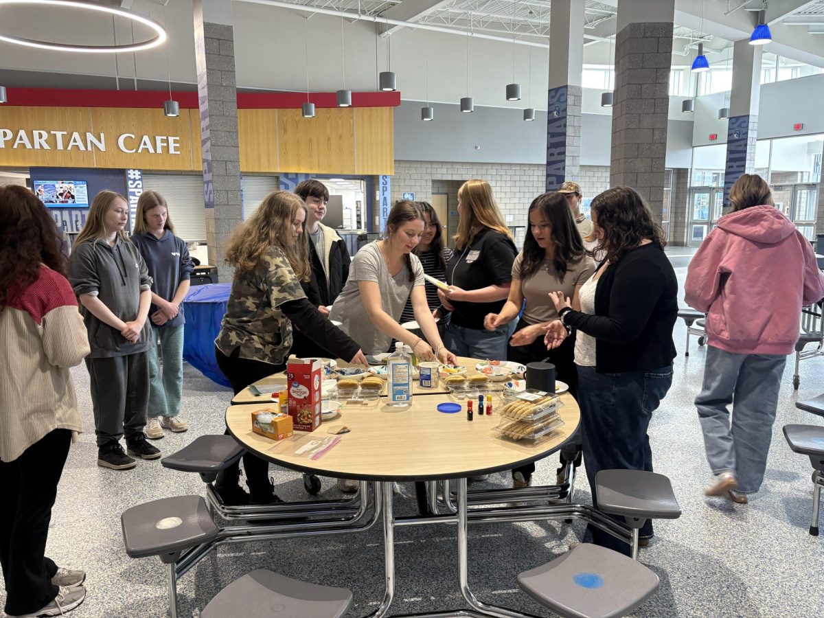 Student's gather to decorate cookies after school for 'Floral Frostings' on May 27, 2025. This event was hosted by seniors enrolled in the dual credit social work class for their required acadmic service learning project. 