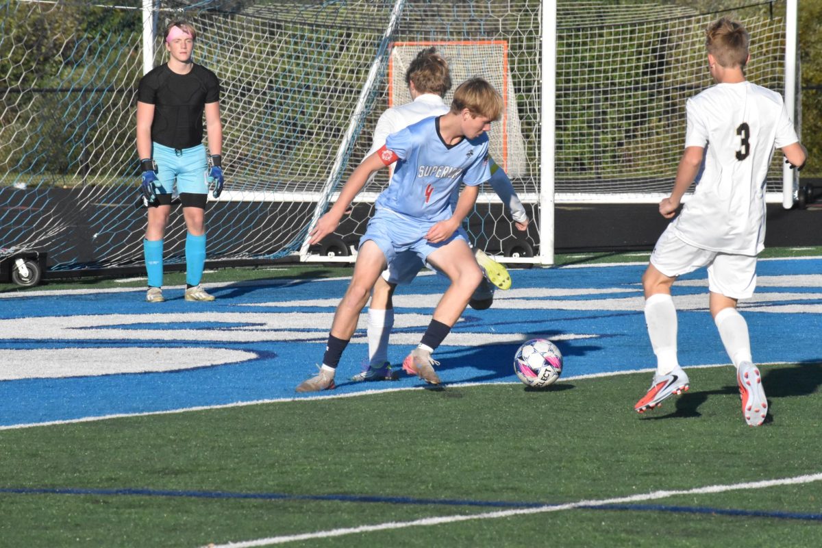 Junior Spencer Kidd (4) dodges an opposing teammate in front of the net in the first half against Hayward on Oct. 7.

