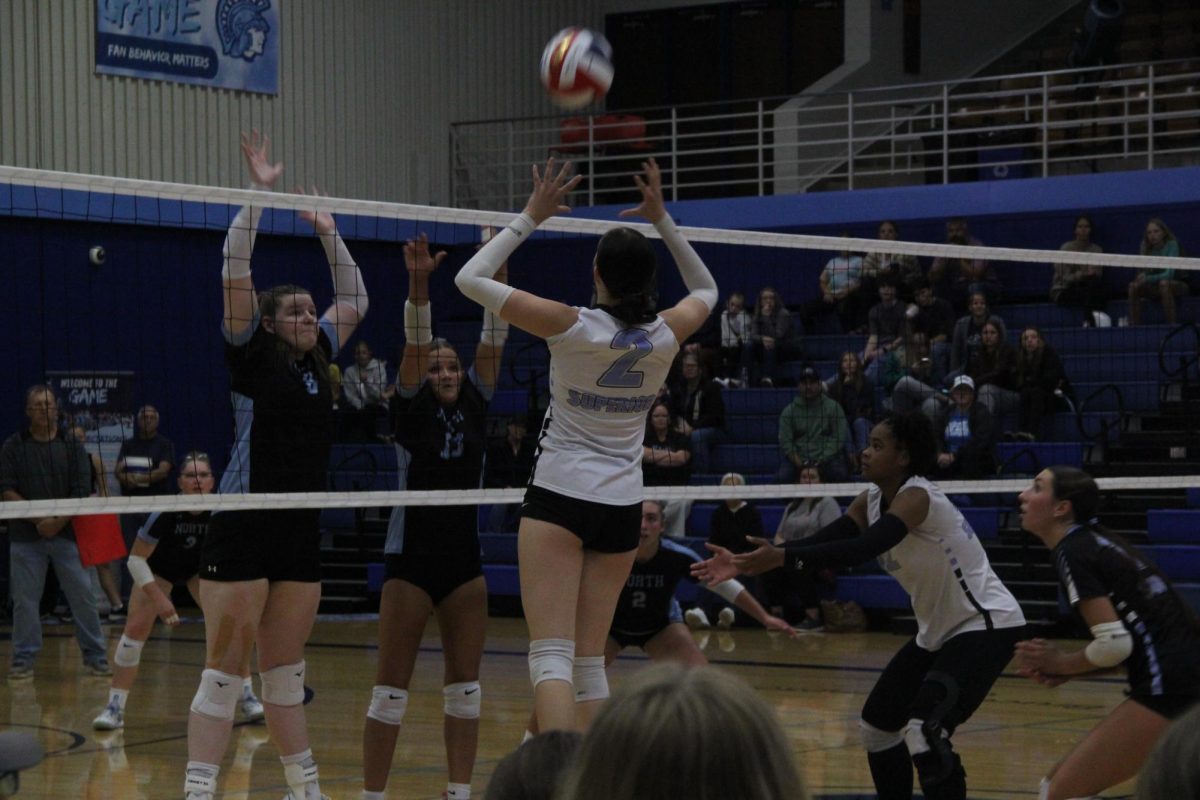 #2 Freshman Kiley Murray MH/ OPP sets the ball over the net to the opposing team at the home game against Eau Claire North Sept.9 
