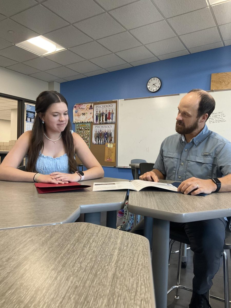 Junior Amelia Vogt and Harvard Model UN advisor Keith Johnson review and discuss last year's HMUN research packet in Johnson's room on Sept 23. Johnson and Vogt review in order to prepare for HMUN to begin. 