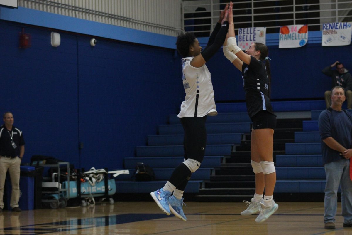 Junior Renaeah Williams (left) and senior Brekyn Warburton (right) celebrate during the first set. 
