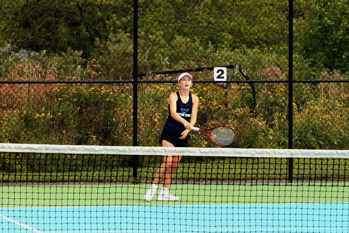 Lily Clark chases a wild ball in a singles match on Aug. 22 against Rice Lake at Spartan NBC Sports Complex.