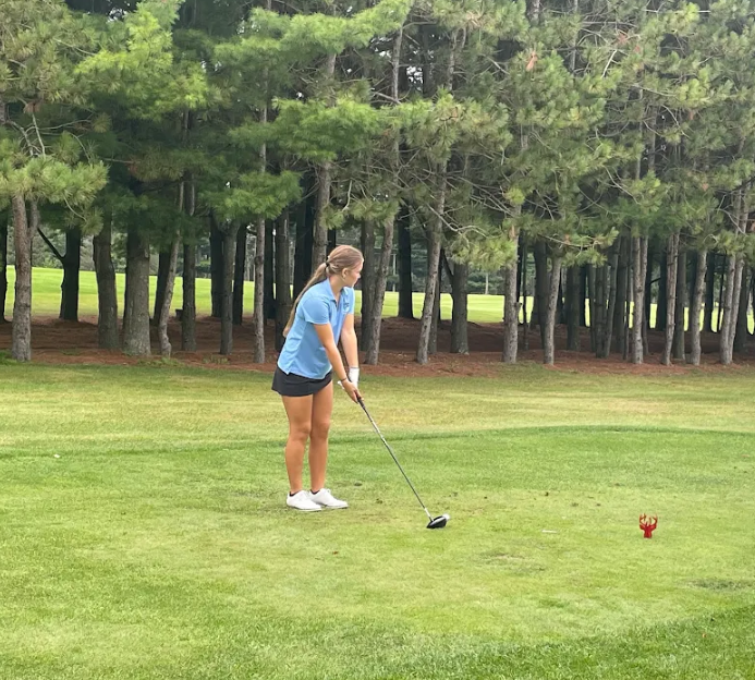 Junior Evie Jenkins prepares to swing at her tee during her meet at Hidden Greens North Golf during Thursday Sept. 11 