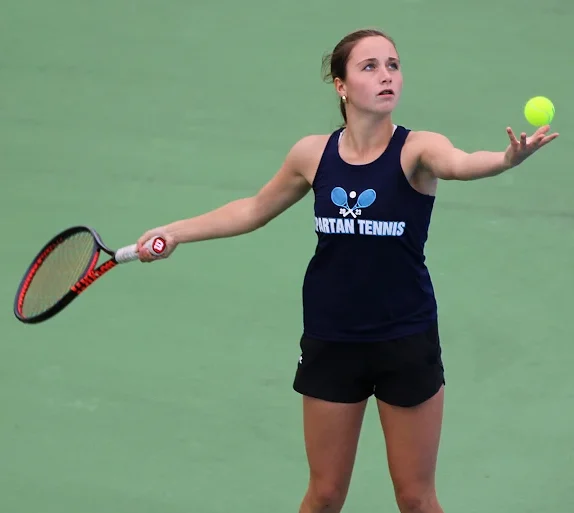 Senior Olivia Mihalik serves up the ball during her match in the 2025 tennis season. 