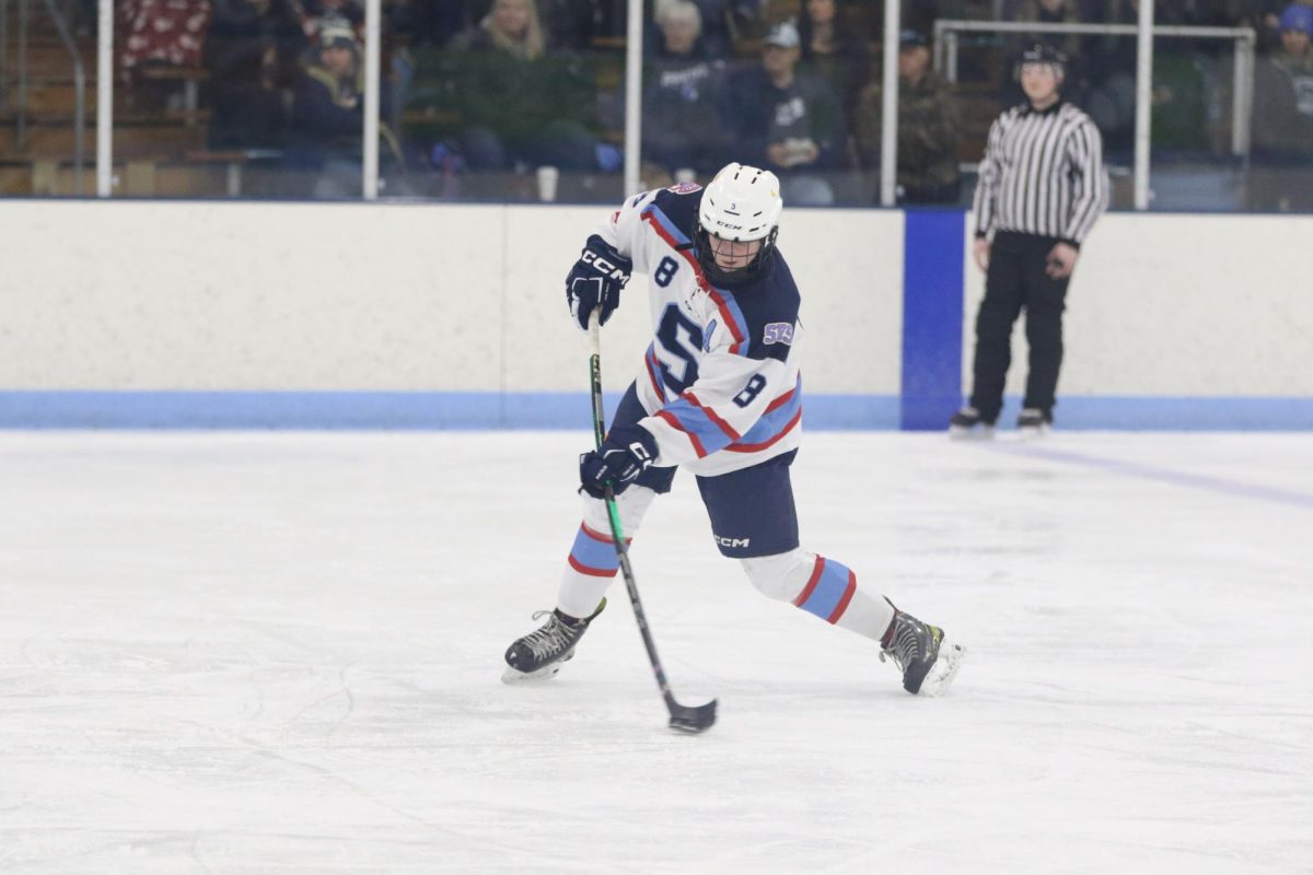 Senior Defencemen Michaela Giessler rifles the puck at the net from the blue line in their game against Hudson. Giessler is a second year assistant captain for the Spartans. On Dec 6, 2025.