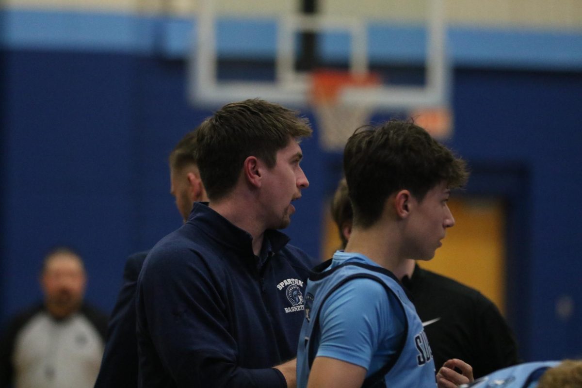 Coach Joe Barker talks to another player during a time out on Dec. 2, in the Spartan area. 

