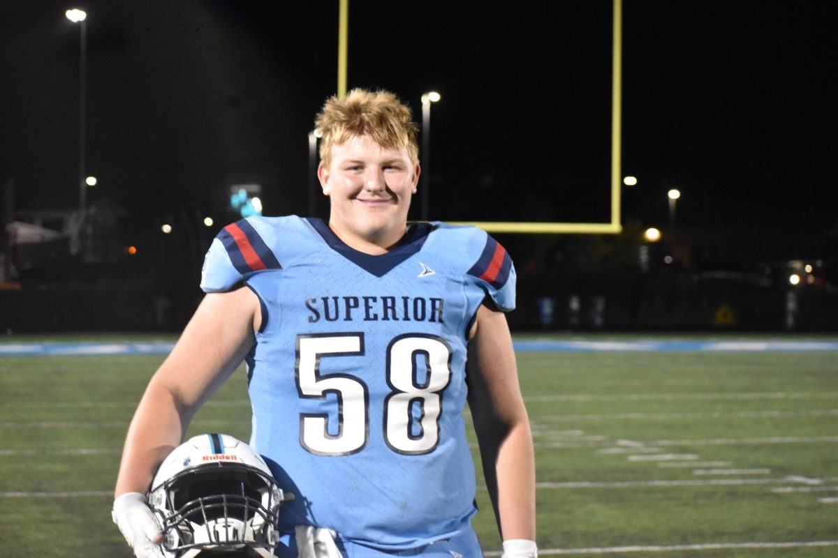Caiden Izzard (58) smiles on the NBC Spartan Sports Complex after a game against Menominee on Sept. 19.
