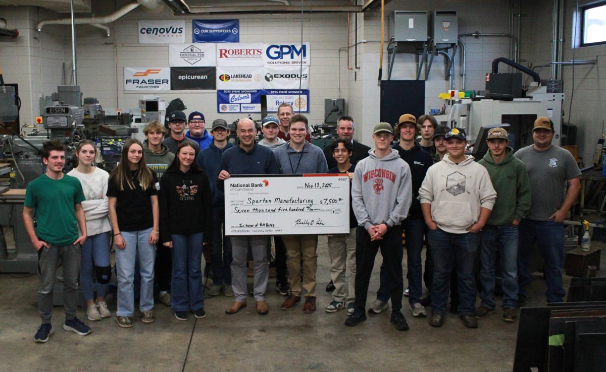 Spartan Manufacturing staff celebrates the big check given to them by the National Bank of Commerce in the Superior High School workshop on Nov. 12, 2025. Marcus Madsen, the previous Spartan Manufacturing President’s grandfather, passed away as a long time worker for the National Bank of Commerce.