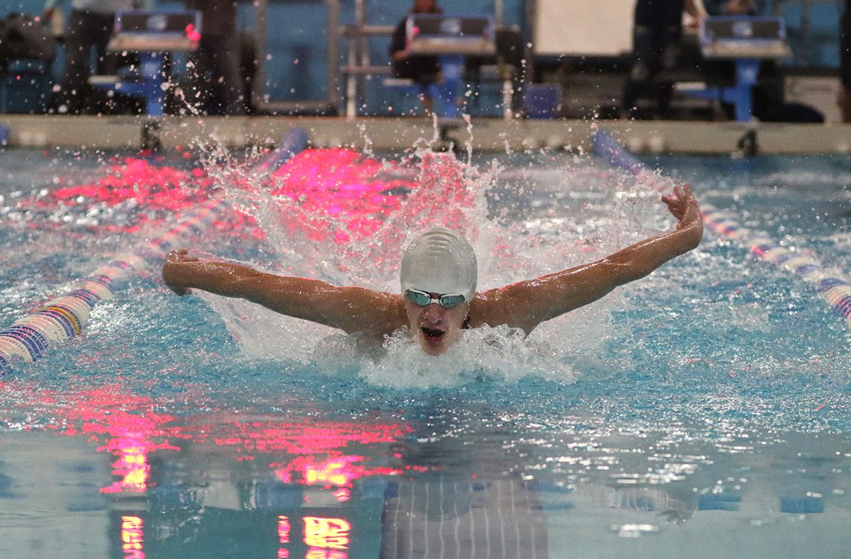 Junior Aiden Pagnucci comes out of the water while doing butterfly during his 200 IM race on Dec. 16.