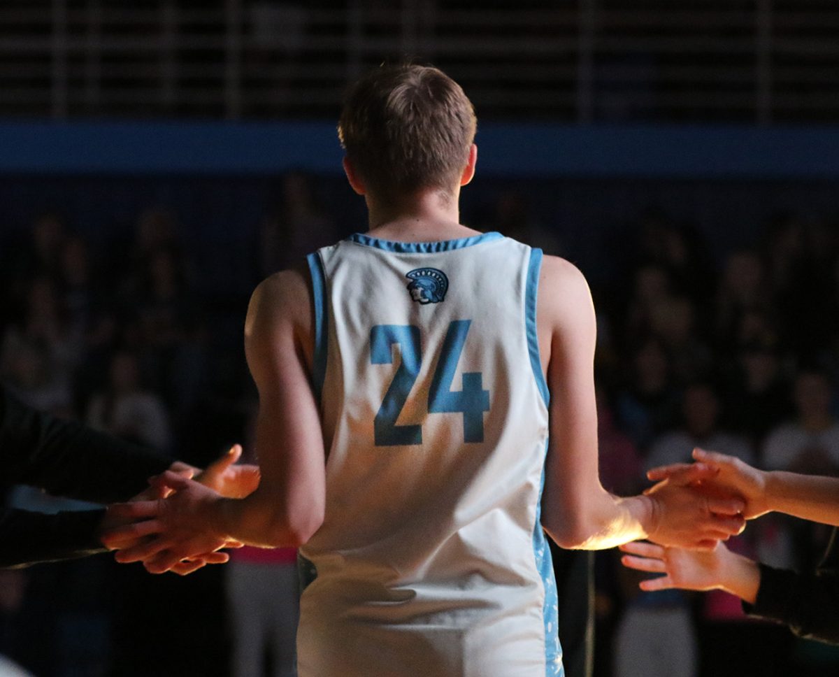 Senior Calvin Anderson runs up while being announced as a start in the game on Dec. 12. 