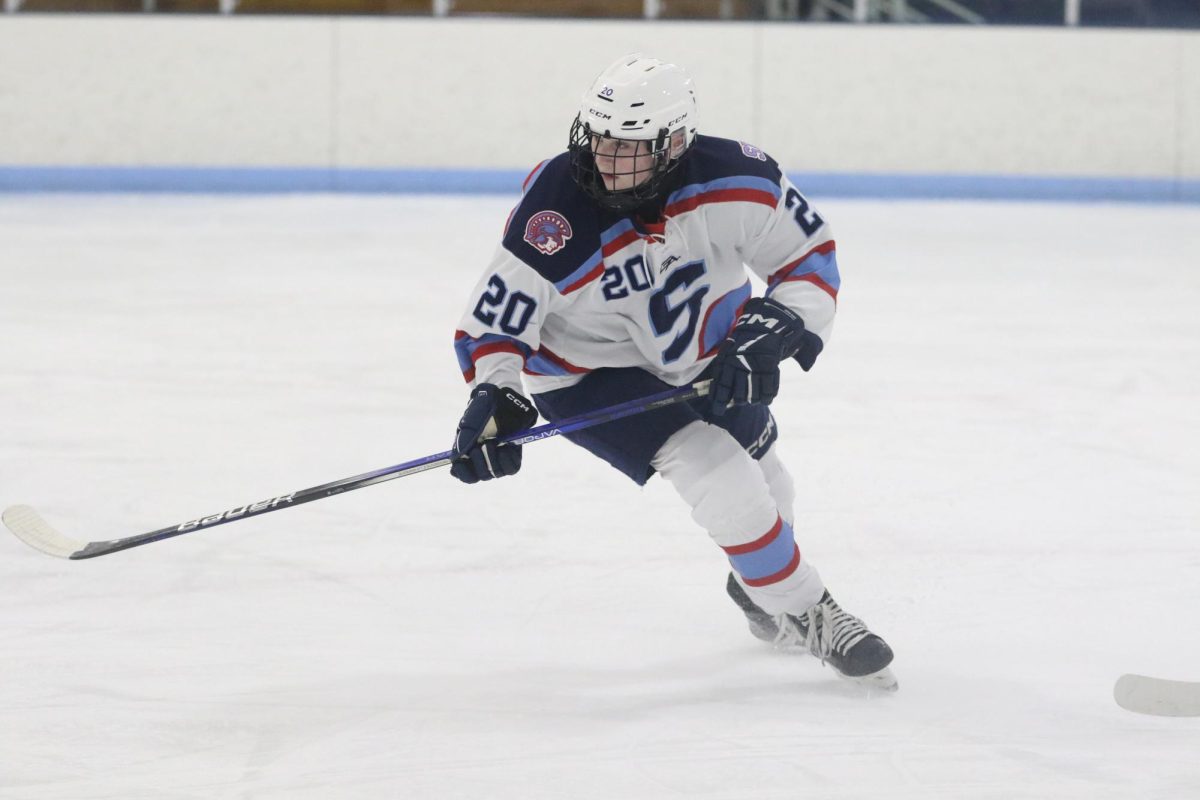 Freshman Nora Madsen crosses over towards the puck in Dec. 2025. 