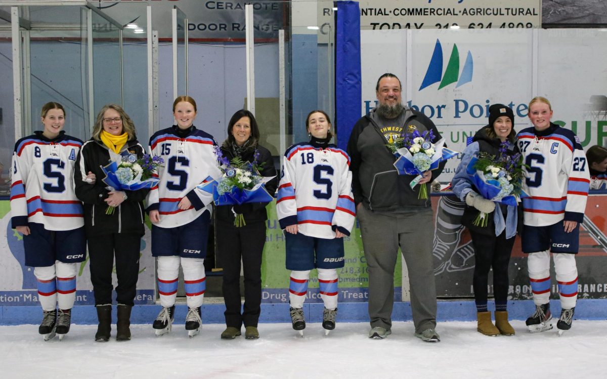 Girls’ hockey seniors standing next to their teachers of choice for Teacher Appreciation Night at their home rink SAHA on Feb. 4 