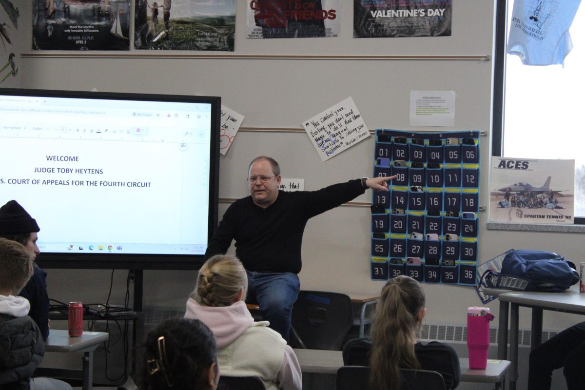 Toby Heytens points over at students (right) as he uses them for a class example on Feb. 23 in social studies teacher Marc Campbell’s classroom.
