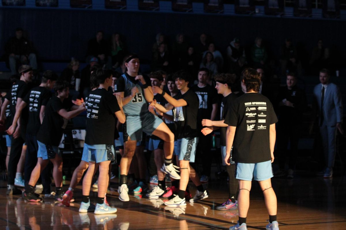 Senior Landon Anrig runs out for the starting lineup on the Spartans Black Out night Jan. 29.
