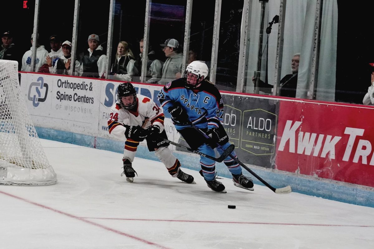 Senior captain Addy Benson skates around the net as a Fusion player attempts to defend her during the first round of the state tournament on March 3, 2026. Benson was named Wisconsin Ms. Hockey the previous night. 
