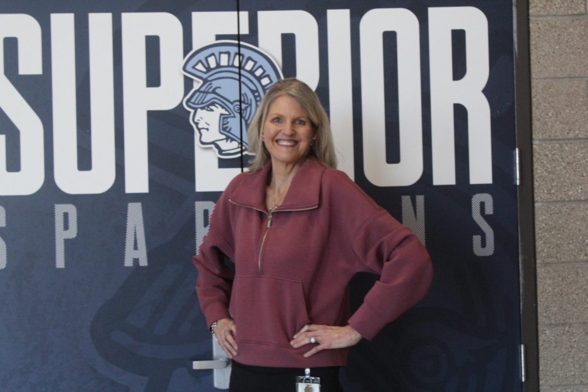 Assistant Principal Kari Saunders poses and smiles outside of the Spartan Arena