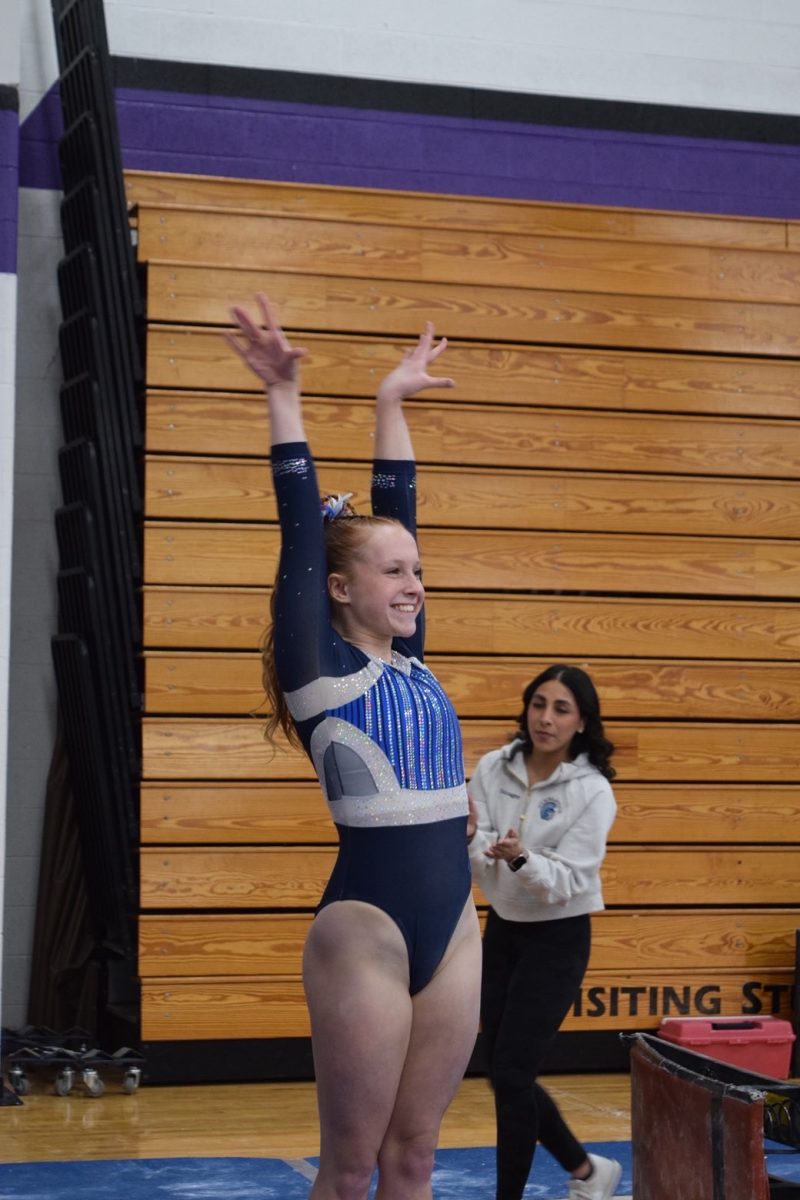 Avery Waletzko salutes after finishing her 9.025 beam routine at WIAA D1 Sectionals at Eau Claire Memorial High School