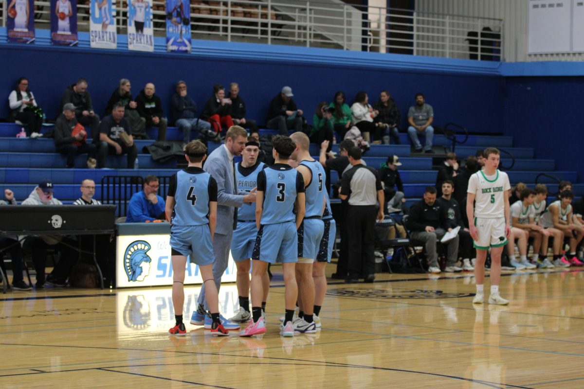 Spartans players (L-R) Cooper LeBard (#4), Beckam Lull (#3), Drew Eisel (#5), and Jayce Rue, huddle during a game against Rock Ridge on Jan. 29
