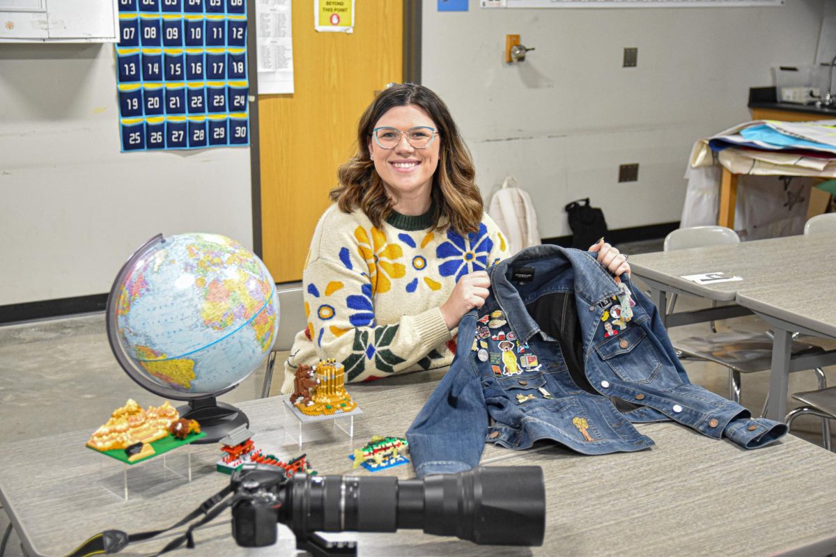 Science teacher Caitlin Zatroch holds her pin jacket while posing for a photo on April 2nd 2026.