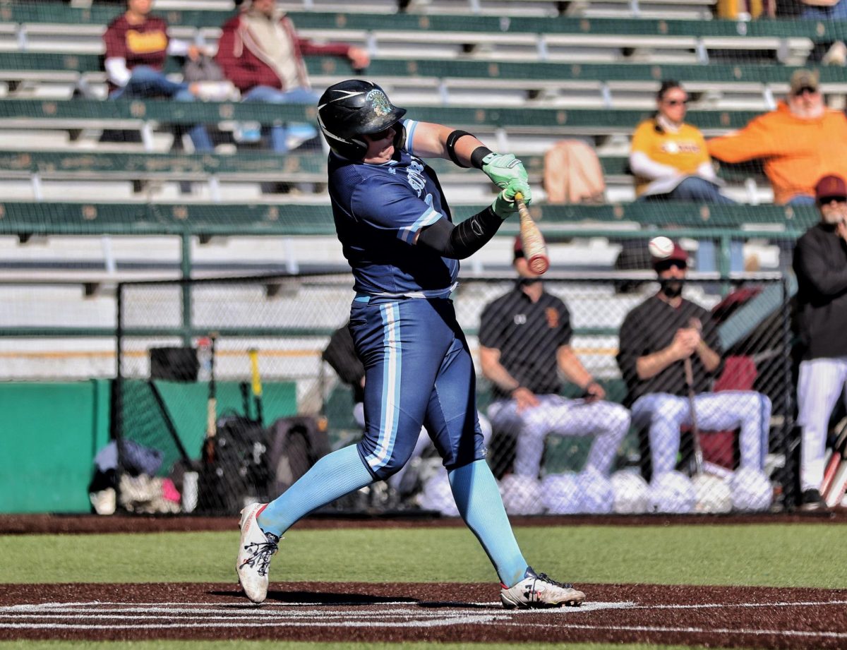 Senior Mike Fiegle swings for the ball during a match on April 21.