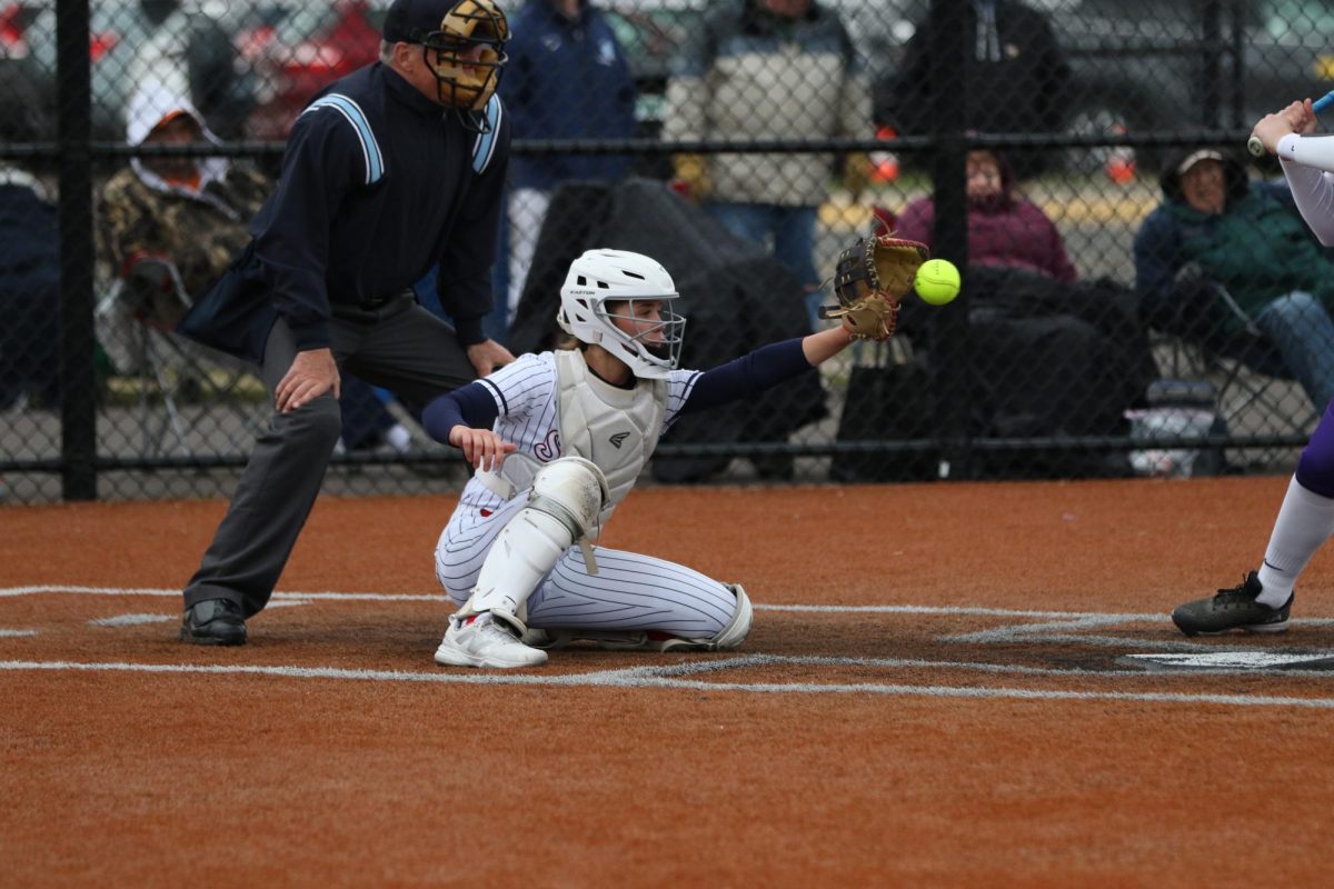 Junior catcher Halle Visger catches the ball behind the plate during their game against the Lumberjacks on April 29. 