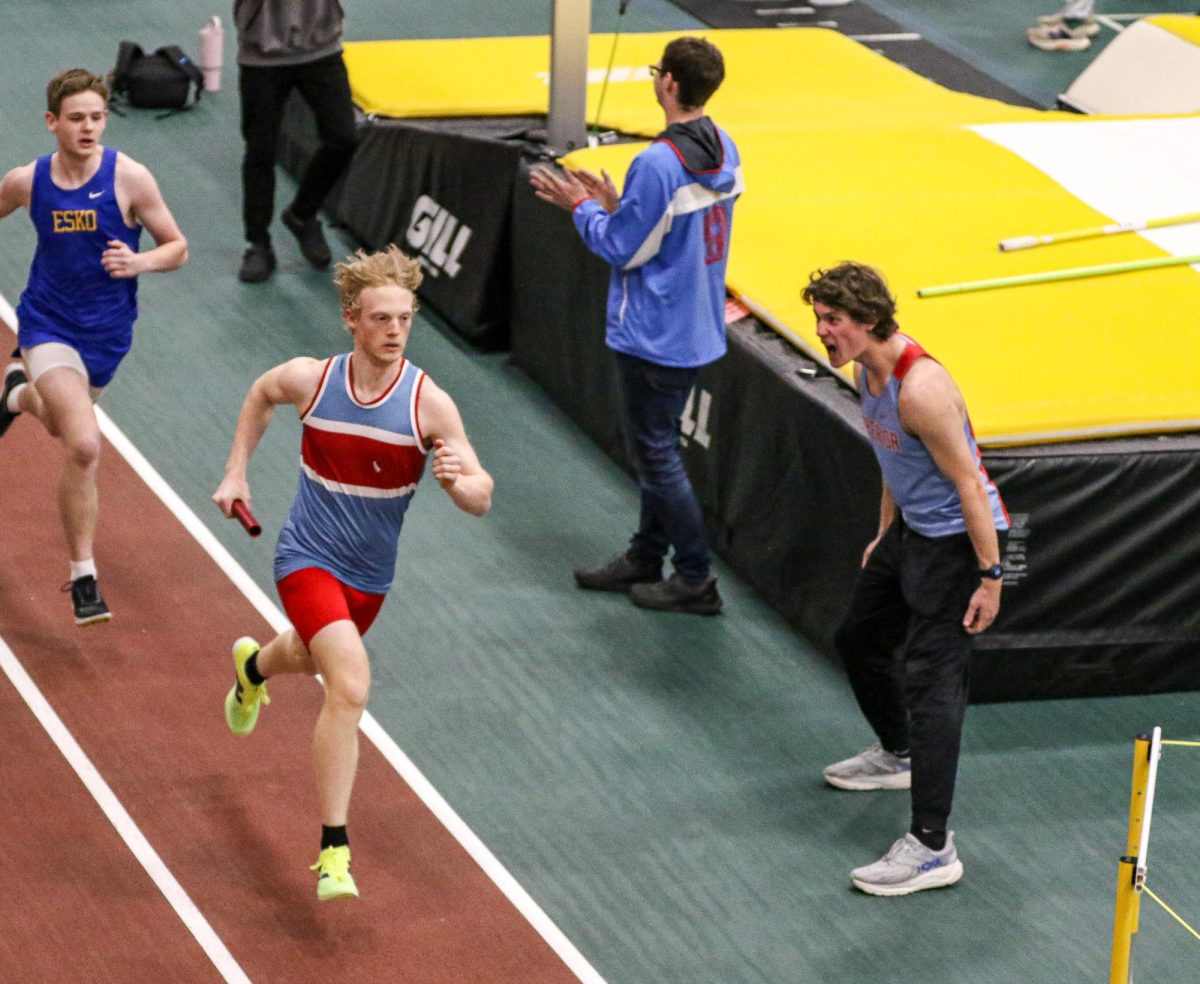 Senior Maxwell Carey cheers on his Superior teammate Bryce Burger during the 4x400 meter event on Apr. 10. 