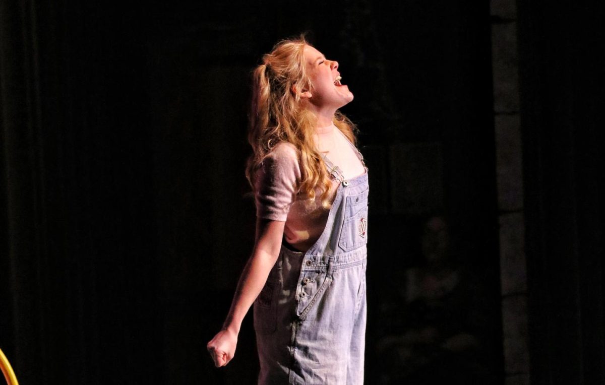 Senior Olivia Wolbert stands center stage singing her solo in the Matilda musical on May 7, 2026. Wolbert is the lead playing Matilda. 
